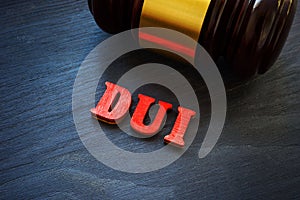 Letters DUI Driving under the influence and hammer.