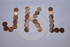 Letters j k l of copper coins insulated on a white sheet of paper.