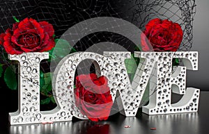 Letters Love on black background with red roses