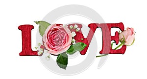 Letters LOVE made of painted wood and pink rose flowers isolated on white