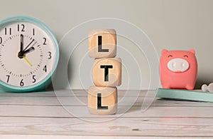 The letters LTL Less than truckload on wooden block