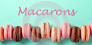 Letters macarons and row of macarons on turquoise