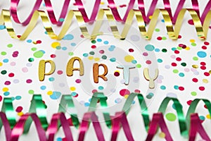 Letters of Party, paper streamers an confetti on white background.