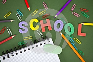 Letters with pencils on green