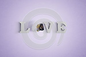 letters spelling LOVE with a heart shaped white balloon