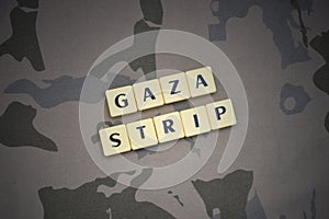Letters with text gaza strip on the khaki background. military concept