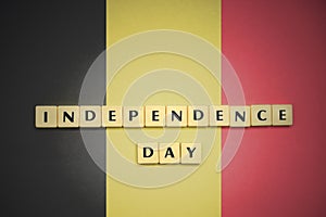 Letters with text independence day on the national flag of belgium.