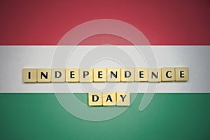 Letters with text independence day on the national flag of hungary.