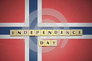 Letters with text independence day on the national flag of norway.
