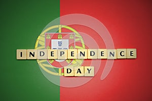 Letters with text independence day on the national flag of portugal.