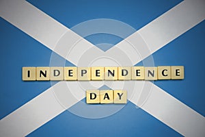 Letters with text independence day on the national flag of scotland.