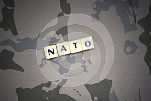 Letters with text nato on the khaki background. military concept