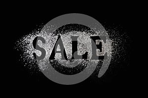 Letters of word sale made with sieved flour on black table background, Concept for preparation for baking, horizontal shot,