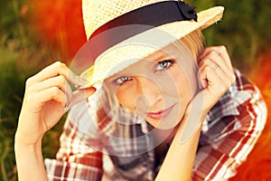 Letting lightleaks enhance this portrait. Lomography style portrait of a young woman sitting in a field.