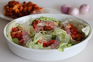 Lettuce chicken wrap. Tandoori chicken bites, sauteed baby corn, fresh cut tomatoes and onions tossed and wrapped in iceberg