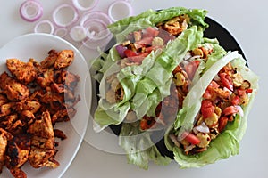 Lettuce chicken wrap. Tandoori chicken bites, sauteed baby corn, fresh cut tomatoes and onions tossed and wrapped in iceberg