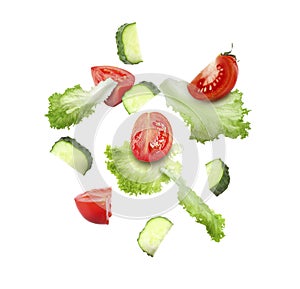 Lettuce leaves, cut cucumber and tomato falling on white background