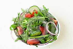 Lettuce mix of rukolly, tomatoes, cucumbers with rings of red on