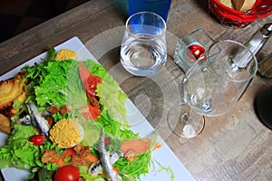 Lettuce salad and mimosas eggs and anchovy with glasses