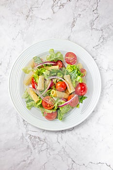 Lettuce tomato cherry salad with penne pasta