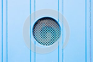 Leuca, Apulia - A traditional old metal peephole in a blue wooden door