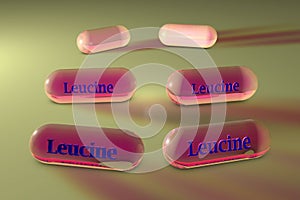 Leucine capsules. Leucine is an essential amino acid used in the biosynthesis of proteins. Medical background photo