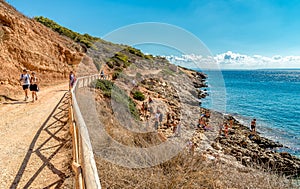Visitors enjoying the Cala Fredda beach during their trip on the Levanzo island in the Mediterranean sea of Sicily.