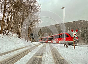 Level crossing with train in winter