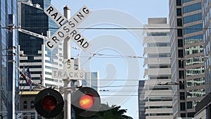 Level crossing warning signal in USA. Crossbuck notice and red traffic light on rail road intersection in California. Railway