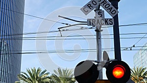 Level crossing warning signal in USA. Crossbuck notice and red traffic light on rail road intersection in California. Railway