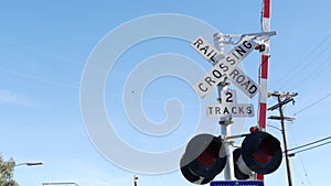 Level crossing warning signal in USA. Crossbuck notice and red traffic light on rail road intersection in California. Railway