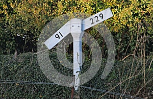 A level or gradient sign by the side of the railway track of the West Somerset heritage railway