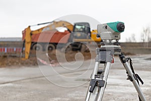 Level or total station at a construction site. Geodetic construction equipment during earthworks