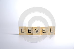 LEVEL - word of wooden blocks with a letter on white background