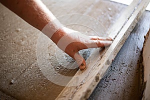 Leveling the cement screed. Fresh wet cement texture. Jellied floor surface. Repair and construction