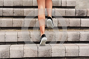 Levelling up. Rearview shot of an unrecognizable young female athlete working out on a flight of stairs at the track.