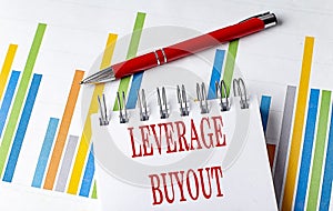 LEVERAGE BUYOUT text on a notebook with chart and pen business concept