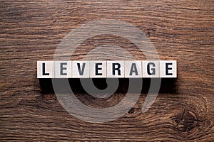 Leverage - word concept on building blocks, text