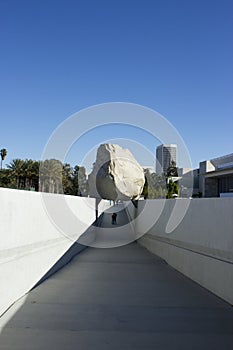 Levitated Mass Over Walkway While Visitors Engage by Walking Under