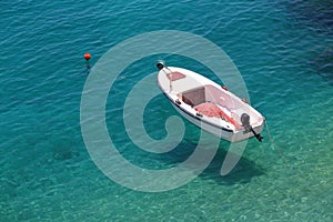 Levitating boat in clear water of Adriatic in Croatia photo