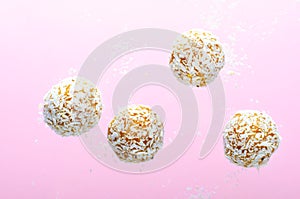 Levitating Coconut Vegan Sweets, Delicious Candy Balls, Healthy Candies on Pink Background