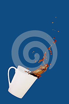 Levitating coffee mug with splashes. Coffee concept. Minimal art trend. Solid classic blue background