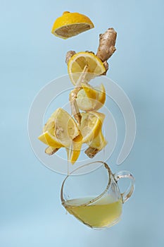 levitating honey lemon slices and ginger over a hot cup of tea
