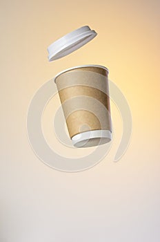 Levitating paper cup with hot coffee