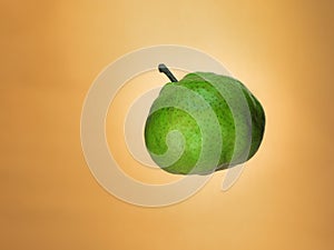 Levitating pear on orange background