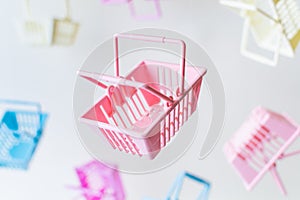 Levitating plastic shopping baskets on white background