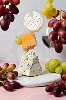 Levitating soft goat cheese, cheddar and blue stilton with red wine and grape