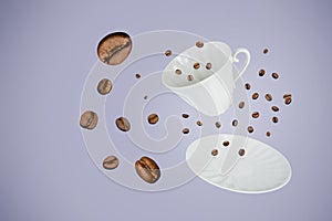 Levitating white porcelain cup and saucer surrounded by coffee beans on gray-blue background