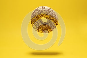 Levitating yellow donut on a yellow background