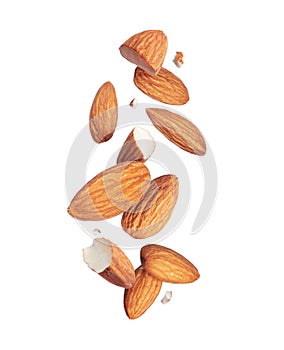 Levitation of whole and cracked almonds close-up in the air isolated on a white background